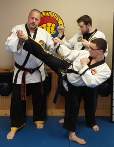 Several black belts from MacKenzie’s Martial Arts will be representing the United States at the TaeKwon-Do World Championships in London. Pictured here are Grandmaster Ken MacKenzie, as well as Andrew Tropp (kicking) and Colin Mazurek, who are instructors at the school’s Pennsauken location.